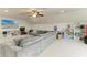 Spacious living room with large sectional, TV, and storage shelving at 10708 52Nd E Ct, Parrish, FL 34219