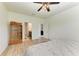 Spacious main bedroom with ceiling fan, wood floors, and ensuite bath at 10708 52Nd E Ct, Parrish, FL 34219