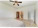 Spacious main bedroom with ceiling fan, wood floors, and ensuite bath at 10708 52Nd E Ct, Parrish, FL 34219