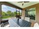 Screened patio features an outdoor dining area and views of the green backyard and landscaping at 10708 52Nd E Ct, Parrish, FL 34219