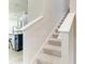 Staircase with carpet floors and white railings, adjacent to the kitchen at 10708 52Nd E Ct, Parrish, FL 34219