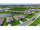 Community aerial view showcasing waterfront homes with lush landscaping and a serene lake setting at 10724 Spring Tide Way, Parrish, FL 34219