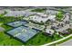 A community aerial showing both the tennis courts and community pool with the lake in the background at 10724 Spring Tide Way, Parrish, FL 34219