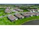 Community aerial view showing lush landscaping, single-Gathering homes, and a scenic lake view at 10724 Spring Tide Way, Parrish, FL 34219