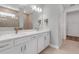 Bright bathroom with double sinks, white cabinets, and a clear view into the tiled shower area and adjacent rooms at 10724 Spring Tide Way, Parrish, FL 34219