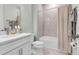 Clean bathroom features tile floors, white vanity and a shower with a neutral curtain at 10724 Spring Tide Way, Parrish, FL 34219