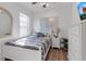 Cozy bedroom with a stylish striped bed, decorative map, natural light, and coordinated decor and furnishings at 10724 Spring Tide Way, Parrish, FL 34219