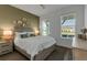 Cozy bedroom with natural light, neutral tones and hardwood floors at 10724 Spring Tide Way, Parrish, FL 34219