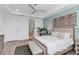 Comfortable bedroom with a view of a bathroom, featuring a queen bed and a ceiling fan at 10724 Spring Tide Way, Parrish, FL 34219