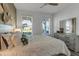 Comfortable bedroom with two windows, hardwood floors and a neutral color scheme at 10724 Spring Tide Way, Parrish, FL 34219