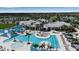 Community clubhouse with a large pool, luxurious seating, palm trees, and well manicured landscaping at 10724 Spring Tide Way, Parrish, FL 34219