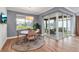 Dining area with a round table next to sliding glass doors that lead to a screened-in porch and outdoor seating at 10724 Spring Tide Way, Parrish, FL 34219