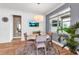 Bright dining area featuring a round table, stylish rug, and a wall-mounted television, creating a cozy and modern space at 10724 Spring Tide Way, Parrish, FL 34219
