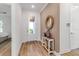 Welcoming entryway with hardwood floors, decorative table and accent mirror at 10724 Spring Tide Way, Parrish, FL 34219