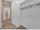 Hallway featuring storage nook with shelves, bench, and coat hooks, providing an organized and stylish transition space at 10724 Spring Tide Way, Parrish, FL 34219