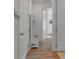 Bright entryway featuring a built-in bench and storage, opening to light-filled interior spaces with wood-look floors at 10724 Spring Tide Way, Parrish, FL 34219