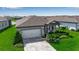 Charming single-story home with a paved driveway and manicured front lawn at 10724 Spring Tide Way, Parrish, FL 34219
