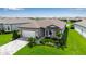 Charming single Gathering home featuring a well-manicured lawn, neutral colors, and a two-car garage at 10724 Spring Tide Way, Parrish, FL 34219