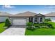 Charming single-Gathering home featuring a well-manicured lawn, beautiful stone accents and a two car garage at 10724 Spring Tide Way, Parrish, FL 34219