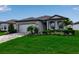 Charming single-Gathering home featuring a well-manicured lawn, beautiful stone accents and a two car garage at 10724 Spring Tide Way, Parrish, FL 34219