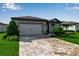 Charming single-Gathering home featuring a well-manicured lawn, beautiful stone accents and a two car garage at 10724 Spring Tide Way, Parrish, FL 34219