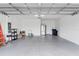 Spacious two-car garage with epoxy floor, wash basin, stainless fridge, and ample storage at 10724 Spring Tide Way, Parrish, FL 34219