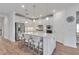 Modern kitchen features an island, stainless steel appliances, and bright white cabinetry at 10724 Spring Tide Way, Parrish, FL 34219