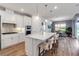 Modern kitchen with island bar, stainless steel appliances and view into dining room at 10724 Spring Tide Way, Parrish, FL 34219