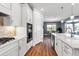 Modern kitchen with island, stainless steel appliances and open floorplan looking into dining area at 10724 Spring Tide Way, Parrish, FL 34219