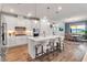 Beautiful kitchen with stainless appliances, a large island and breakfast bar, and an adjacent dining area at 10724 Spring Tide Way, Parrish, FL 34219