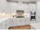Well-lit kitchen boasts stainless steel appliances, sleek cabinetry, and quartz countertops at 10724 Spring Tide Way, Parrish, FL 34219