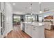 Bright kitchen features modern stainless appliances, a large island, and a view into the adjacent living area at 10724 Spring Tide Way, Parrish, FL 34219