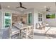 Covered patio with sleek ceiling fans, outdoor seating, dining area, and outdoor TV for a stylish experience at 10724 Spring Tide Way, Parrish, FL 34219