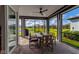Relaxing screened lanai with ceiling fan, dining set, and serene water views, ideal for outdoor enjoyment at 10724 Spring Tide Way, Parrish, FL 34219