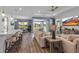 Inviting living room with comfortable seating, sleek hardwood floors, and a seamless indoor-outdoor flow to the lanai at 10724 Spring Tide Way, Parrish, FL 34219