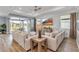Spacious living room featuring hardwood floors, neutral decor and an abundance of natural light at 10724 Spring Tide Way, Parrish, FL 34219