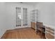 Cozy office featuring glass double doors, complemented by a stylish desk and shelving, creating a functional workspace at 10724 Spring Tide Way, Parrish, FL 34219