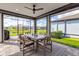 Screened patio with dining set, outdoor seating and a view of the backyard and pond at 10724 Spring Tide Way, Parrish, FL 34219