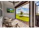 Covered patio seating area featuring a ceiling fan and a beautiful water view, with a flatscreen TV on the wall at 10724 Spring Tide Way, Parrish, FL 34219