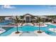 Stunning aerial view of a resort style pool with palm trees and large clubhouse on a sunny day at 10724 Spring Tide Way, Parrish, FL 34219
