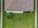 Aerial view of the property showcasing the lawn, house, and screened in patio at 11015 High Noon Trl, Parrish, FL 34219