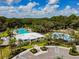 Aerial view of community pool and recreation area, showcasing pools and water features for Gathering fun at 11015 High Noon Trl, Parrish, FL 34219