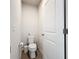 Small, modern powder room featuring a white toilet and matching accessories, providing a simple and clean design at 11015 High Noon Trl, Parrish, FL 34219