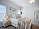 Bright bedroom featuring a neutral color scheme and a large window, creating a serene atmosphere at 11015 High Noon Trl, Parrish, FL 34219