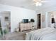 Spacious bedroom with a ceiling fan, TV, and openings to other rooms in the house at 11015 High Noon Trl, Parrish, FL 34219