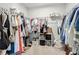 Organized walk-in closet with ample hanging space, shelving, and storage bins, designed for optimal storage at 11015 High Noon Trl, Parrish, FL 34219