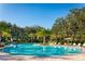 Community pool area provides ample seating and plenty of room to relax at 11015 High Noon Trl, Parrish, FL 34219