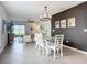 Bright dining area features modern lighting and an accent wall that adjoins the living room at 11015 High Noon Trl, Parrish, FL 34219