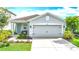 Charming single-Gathering home with a well-manicured lawn, features a two-car garage, and a welcoming front entrance at 11015 High Noon Trl, Parrish, FL 34219