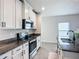 Well-equipped kitchen with stainless steel appliances, granite countertops and white cabinets at 11015 High Noon Trl, Parrish, FL 34219